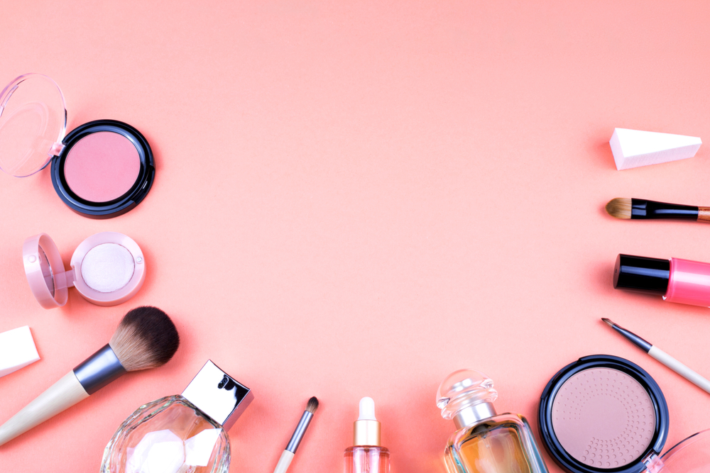 a group of makeup products on a pink background