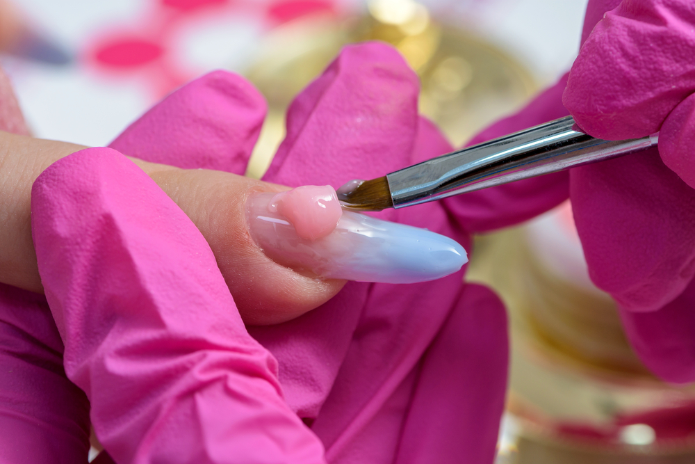 a person painting a nail
